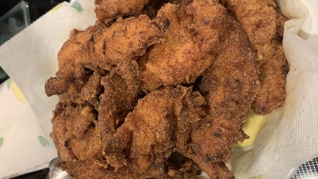 A few batches of cooked chicken tenders. 